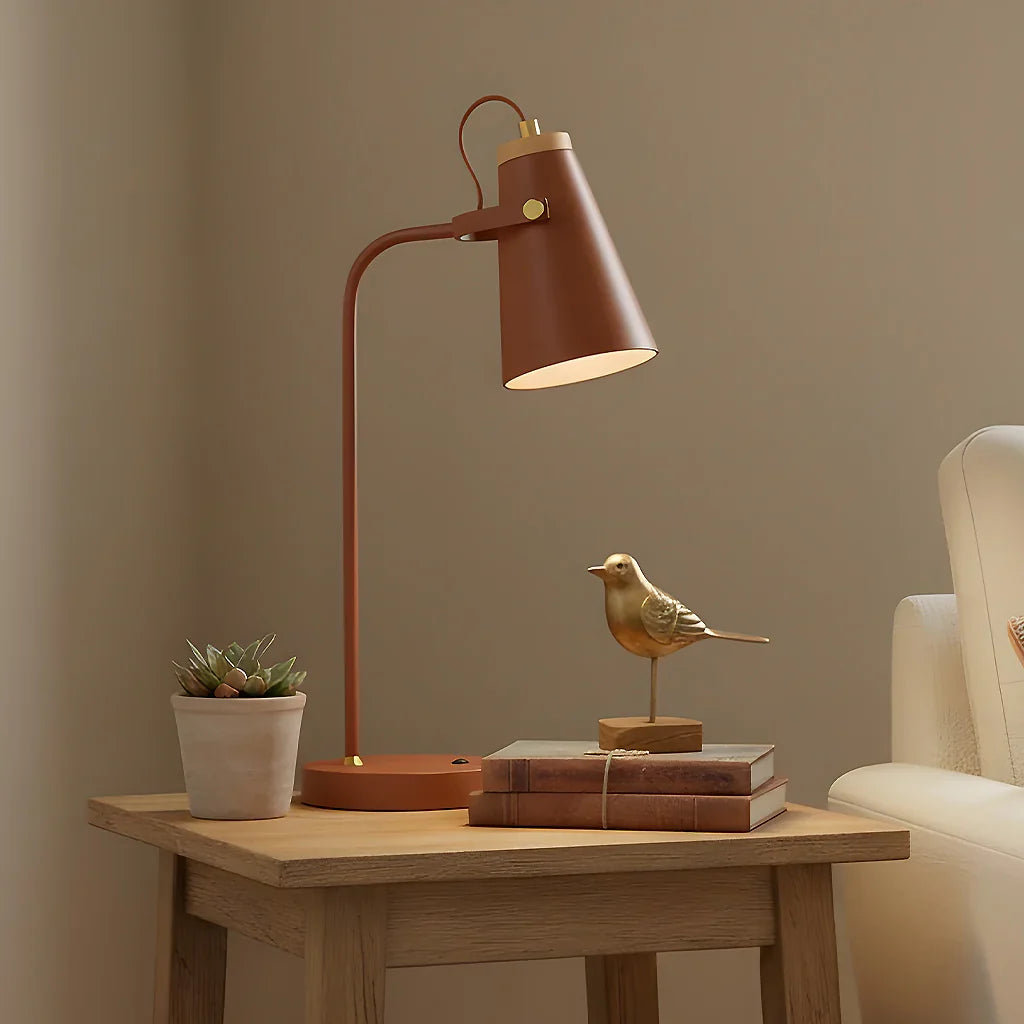 Brown table lamp on a wooden side table with decorative items against a beige wall.