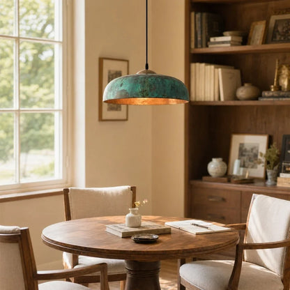 Dining room with wooden table, chairs, and a pendant light fixture.
