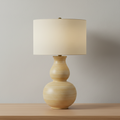 Honorine mustard ceramic table lamp shown from the front on white